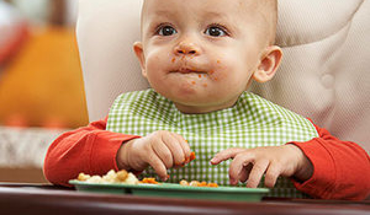 baby eating in high chair Children s Physicians Medical Group